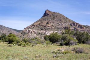 Grassy Meadow Below Rocky Hill
