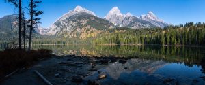 The shores of Taggart Lake silhouetted against the Teton Mountains rising high above. Grand Teton National Park, Wyoming