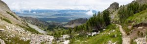 The Alaska Basin Trail descending through alpine terrain above the valley of Jackson Hole. Grand Teton National Park, Wyoming