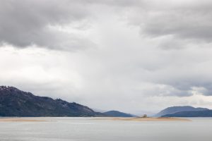 Rain showers and stormy weather passing over northern Jackson Lake during low water levels. Grand Teton National Park, Wyoming
