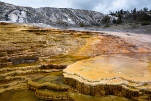 Mound Terrace pouring water into lower pools and terraces built up from travertine at Mammoth Hot Springs. Yellowstone National Park, Wyoming