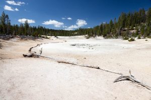 The Clear Lake Trail winding through a geyser basin as it passes by a mud pot. Yellowstone National Park, Wyoming