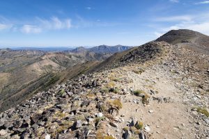 The Avalanche Peak Trail winding through alpine terrain as Absaroka Mountain peaks rise in the distance. Yellowstone National Park, Wyoming