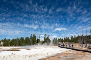 Whispy clouds passing over a crowd on the Fountain Paint Pots trail of the Lower Geyser Basin. Yellowstone National Park, Wyoming